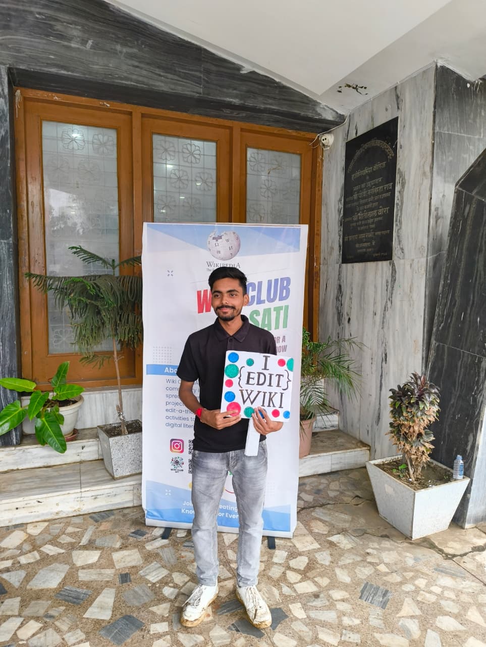 The Wiki Club at SATI (Samrat Ashok Technological Institute) hosts an interactive outreach event featuring a standee designed to promote awareness of open-source principles and the role of collaborative knowledge-sharing platforms such as Wikipedia. The standee is accompanied by cutouts of key concepts related to open-source software and community-driven editing. This initiative encourages students and faculty to engage with open-source initiatives by posing for photographs, thereby contributing to a broader dialogue on the importance of open access to information and the power of collective contribution. Through this visual engagement, the Wiki Club aims to foster greater involvement in the global open-source movement. concerning Multimodal Prompt Engineering in Gemini: Dissecting Latent Space Dynamics and Semantic Control in Generative Image Editing